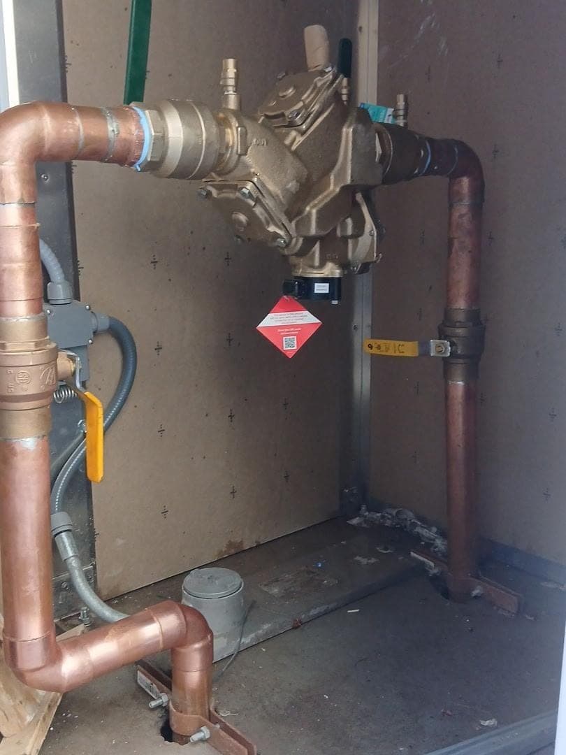 Backflow preventer installed on a building’s copper water service