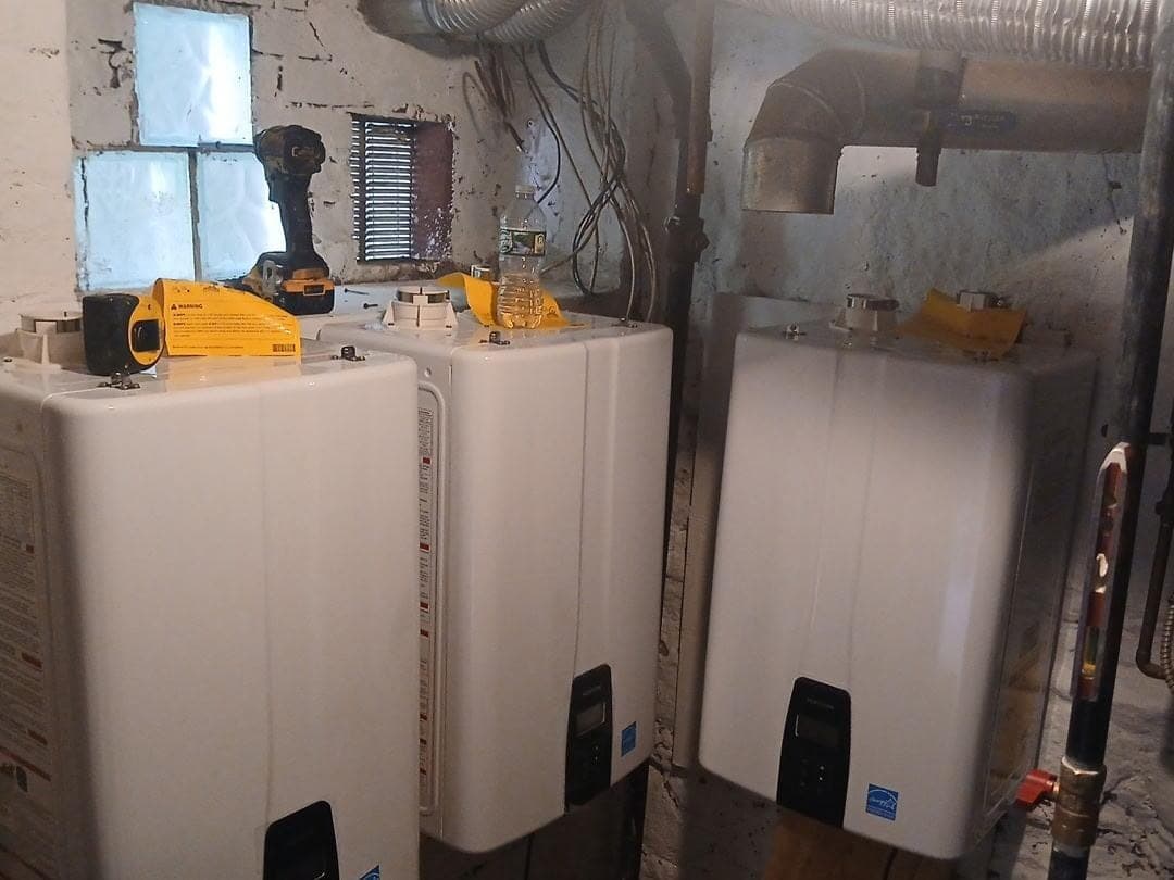 Wall-mounted tankless water heaters with gas and water connections