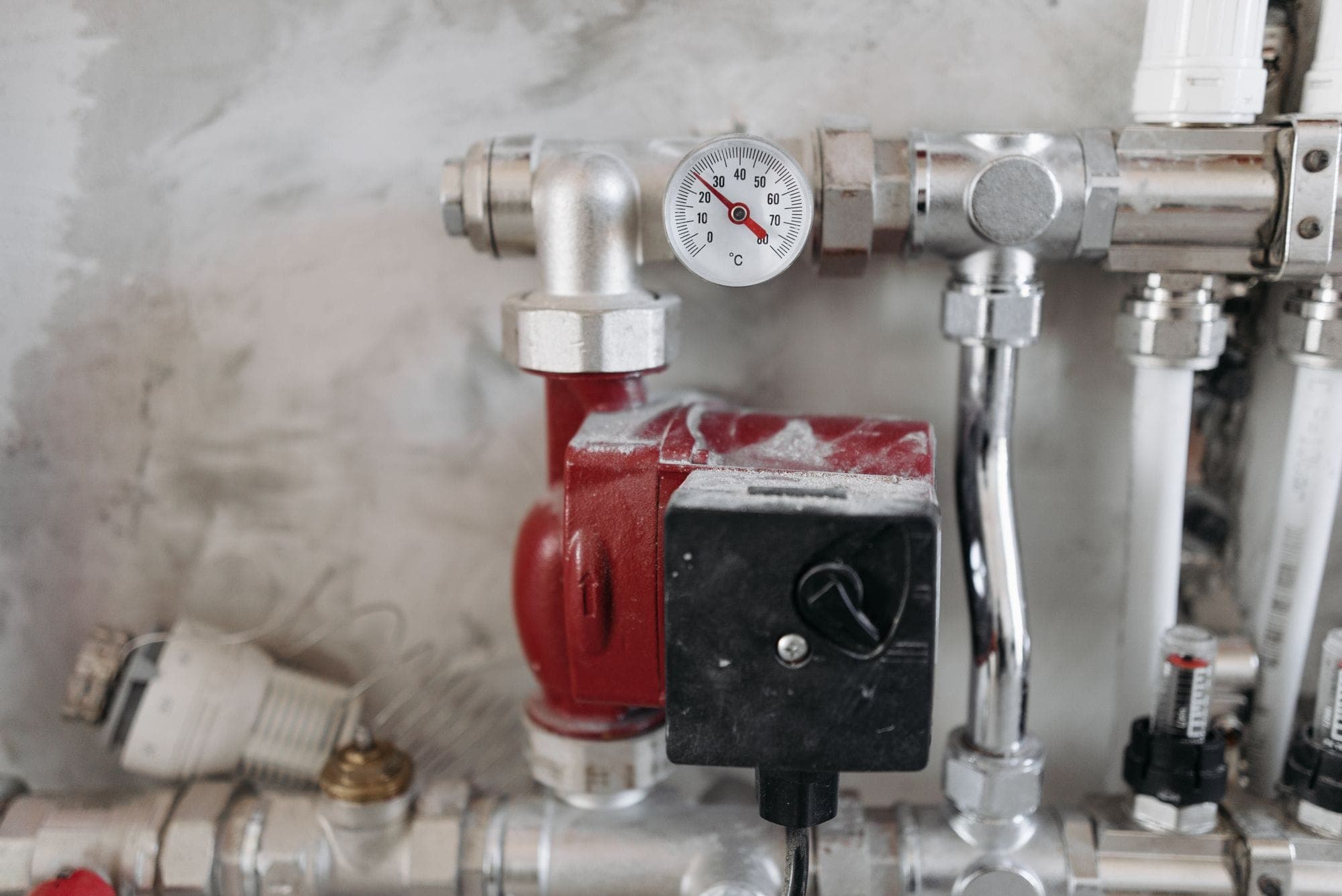 Pressure gauge, pump and valves on a water distribution manifold